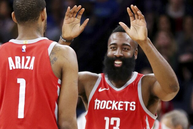 Houston Rockets James Harden (13) celebrates with teammate Trevor Ariza (1) after hitting a three-point shot against the Minnesota Timberwolves in the fourth quarter of an NBA basketball game Sunday, March 18, 2018, in Minneapolis. The Rockets defeated the Timberwolves 129-120. (AP Photo/Andy Clayton-King)