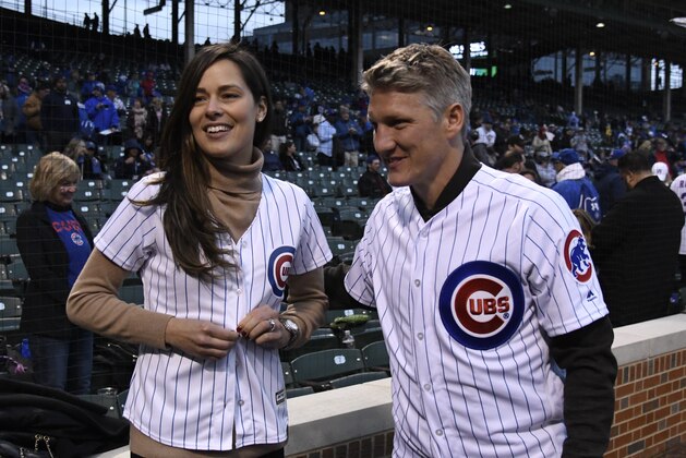 CHICAGO, IL - MAY 02: Former tennis player and French Open champion Ana Ivanovic tries on a Cubs jersey as her husband Chicago Fire Soccer player Bastian Schweinsteiger watches before the game between the Chicago Cubs and the Philadelphia Phillies on May 2, 2017 at Wrigley Field  in Chicago, Illinois. (Photo by David Banks/Getty Images)