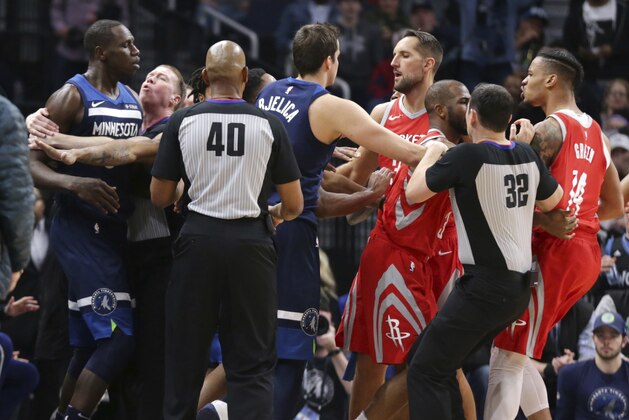 Minnesota Timberwolves center Gorgui Dieng (5) and Houston Rockets forward Gerald Green (14) are restrained in the fourth quarter of an NBA basketball game Sunday, March 18, 2018, in Minneapolis. Green was ejected on the play as the Rockets defeated the Timberwolves 129-120. (AP Photo/Andy Clayton-King)