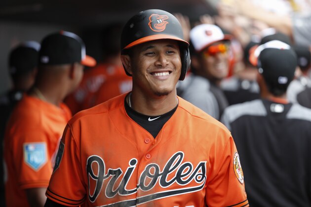 Baltimore Orioles' Manny Machado celebrates in the dugout after hitting a three-run home run off Pittsburgh Pirates relief pitcher Damien Magnifico in the fourth inning of a spring training baseball game, Friday, March 2, 2018, in Sarasota, Fla. (AP Photo/John Minchillo)