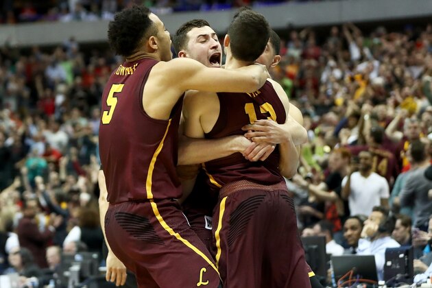 DALLAS, TX - MARCH 17:  Clayton Custer #13 of the Loyola Ramblers is mobbed by teammates after hitting the game-winning shot to beat the Tennessee Volunteers 63-62 in the second round of the 2018 NCAA Tournament at the American Airlines Center on March 17, 2018 in Dallas, Texas.  (Photo by Ronald Martinez/Getty Images)