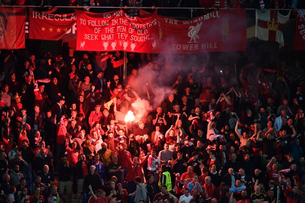 Liverpool's supporters burn a flare as they celebrate Liverpool after  Liverpool opened the score  during the UEFA Europa League final football match between Liverpool FC and Sevilla FC at the St Jakob-Park stadium in Basel, on May 18, 2016.   AFP PHOTO / FABRICE COFFRINI / AFP / FABRICE COFFRINI        (Photo credit should read FABRICE COFFRINI/AFP/Getty Images)