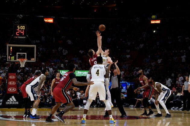 MIAMI, FL - MARCH 19: Kelly Olynyk #9 of the Miami Heat and Nikola Jokic #15 of the Denver Nuggets tip-off to begin overtime at American Airlines Arena on March 19, 2018 in Miami, Florida. NOTE TO USER: User expressly acknowledges and agrees that, by downloading and or using this photograph, User is consenting to the terms and conditions of the Getty Images License Agreement. (Photo by Rob Foldy/Getty Images)