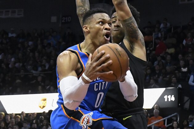 Oklahoma City Thunder guard Russell Westbrook (0) goes to the basket with Atlanta Hawks guard Isaiah Taylor defending during the second half of an NBA basketball game, Tuesday, March 13, 2018, in Atlanta. Oklahoma City won 119-107. (AP Photo/John Amis)