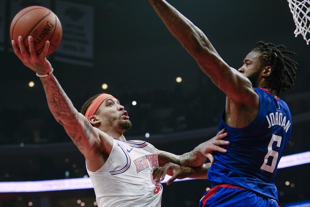 New York Knicks forward Michael Beasley, left, goes to the basket while defended by Los Angeles Clippers center DeAndre Jordan during the first half of an NBA basketball game Friday, March 2, 2018, in Los Angeles. (AP Photo/Ringo H.W. Chiu)