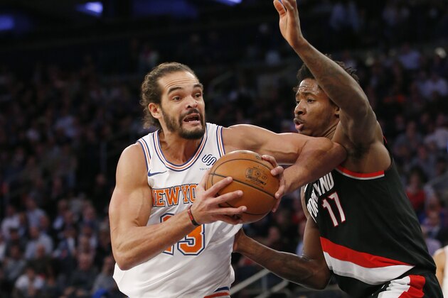 New York Knicks center Joakim Noah (13), making his season debut after a suspension for performance enhancing drugs, goes up against Portland Trail Blazers forward Ed Davis (17) during the first half of an NBA basketball game in New York, Monday, Nov. 27, 2017. (AP Photo/Kathy Willens)