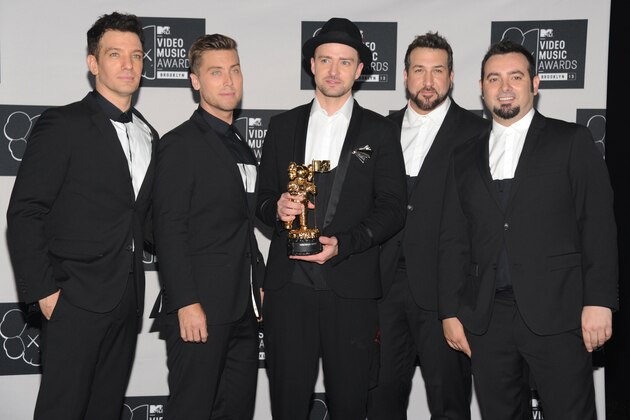 FILE - In this Aug. 25, 2013, file photo, Justin Timberlake, center, winner of the video vanguard award poses backstage with, from left, JC Chasez, Lance Bass, Joey Fatone and Chris Kirkpatrick of NSYNC at the MTV Video Music Awards at the Barclays Center in New York. Timberland and the band's Twitter account posted a picture of the group celebrating Chasez's 40th birthday party on Aug. 9, 2016. (Photo by Evan Agostini/Invision/AP, File)