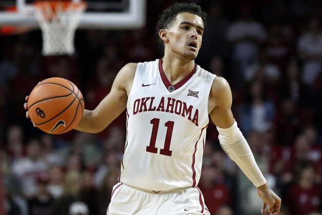 FILE - In this Feb. 17, 2018, file photo, Oklahoma guard Trae Young (11) brings the ball upcourt during the second half of an NCAA college basketball game against Texas in Norman, Okla. Young leads the country in both scoring and assists entering the final weekend of the regular season.  (AP Photo/Sue Ogrocki, File)