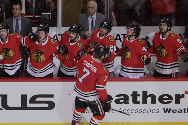 Chicago Blackhawks defenseman Brent Seabrook (7) is congratulated for his goal against the Colorado Avalanche during the first period of an NHL hockey game Tuesday, March 20, 2018, in Chicago. (AP Photo/David Banks)