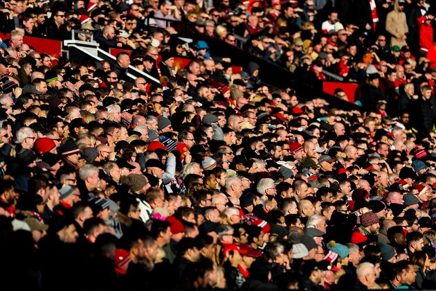 MANCHESTER, ENGLAND - FEBRUARY 25: Fans of Manchester United look on in the sun during the Premier League match between Manchester United and Chelsea at Old Trafford on February 25, 2018 in Manchester, England. (Photo by Matthew Ashton - AMA/Getty Images)