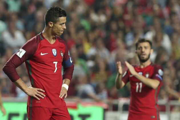 Portugal's Cristiano Ronaldo, left, reacts during the World Cup Group B qualifying soccer match between Portugal and Switzerland at the Luz stadium in Lisbon, Tuesday, Oct. 10, 2017. (AP Photo/Armando Franca)