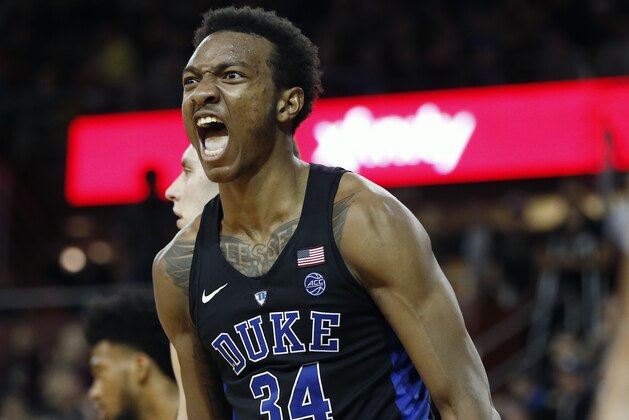 FILE - In this Dec. 9, 2017, file photo, Duke's Wendell Carter Jr. reacts after scoring during the second half of an NCAA college basketball game against Boston College, in Boston. Bank records and other expense reports that are part of a federal probe into college basketball list a wide range of impermissible payments from agents to at least two dozen players or their relatives, according to documents obtained by Yahoo Sports. Yahoo said Friday, Feb. 23, 2018, that the documents obtained in discovery during the investigation link current players including Michigan State's Miles Bridges, Duke's Wendell Carter and Alabama's Collin Sexton to potential benefits that would be violations of NCAA rules. (AP Photo/Michael Dwyer, File)