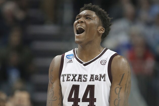 Texas A&M's Robert Williams celebrates after a dunk against Providence during the second half of a first-round game in the NCAA men's college basketball tournament in Charlotte, N.C., Friday, March 16, 2018. (AP Photo/Bob Leverone)