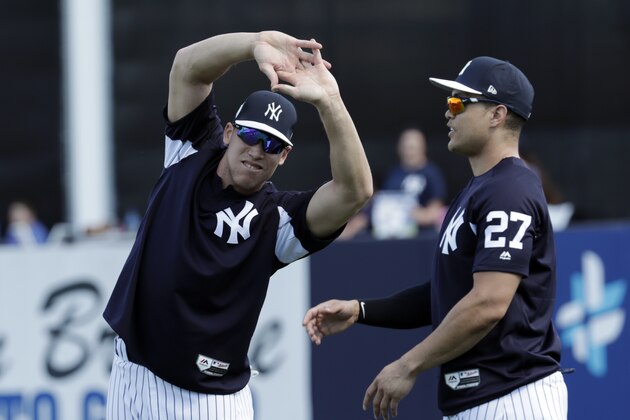 New York Yankees' Aaron Judge, left, and Giancarlo Stanton stretch at baseball spring training camp, Monday, Feb. 19, 2018, in Tampa, Fla. (AP Photo/Lynne Sladky)