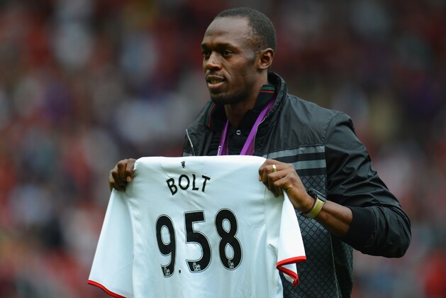 MANCHESTER, ENGLAND - AUGUST 25:  Jamaican Athlete Usain Bolt poses with a United shirt prior to the Barclays Premier League match between Manchester United and Fulham at Old Trafford on August 25, 2012 in Manchester, England.  (Photo by Shaun Botterill/Getty Images)