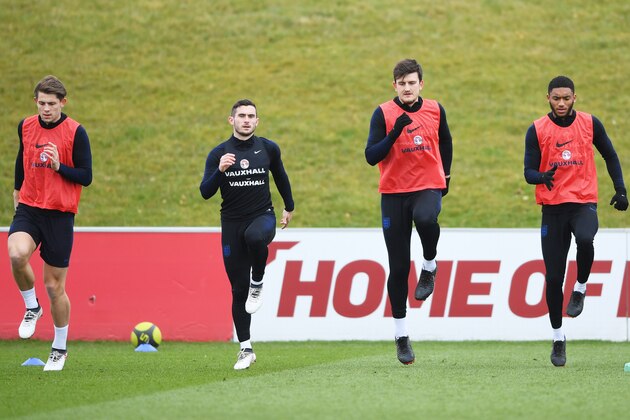 BURTON-UPON-TRENT, ENGLAND - MARCH 22:  (L-R) James Tarkowski, Lewis Cook, Harry Maguire and Joe Gomez warm up during an England training session on the eve of their international friendly against the Netherlands at St Georges Park on March 22, 2018 in Burton-upon-Trent, England.  (Photo by Gareth Copley/Getty Images)