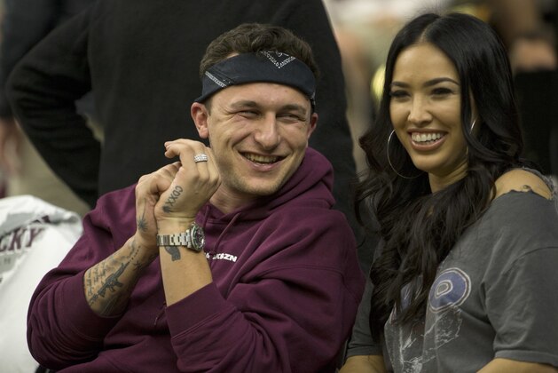 Former Texas A&M quarterback Johnny Manziel sits with his fiancé Bre Tiesi during an NCAA college basketball game between Kentucky and Texas A&M Saturday, Feb. 10, 2018, in College Station, Texas. (AP Photo/Sam Craft)