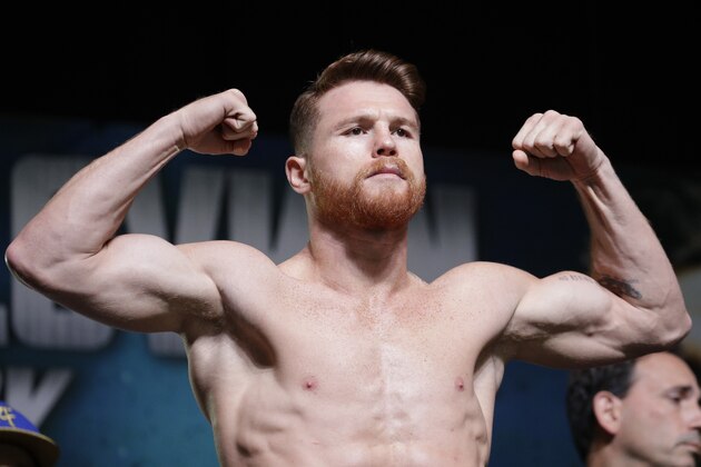 Canelo Alvarez poses on the scale during a weigh-in Friday, Sept. 15, 2017, in Las Vegas. Alvarez is scheduled to fight Gennady Golovkin in a middleweight title fight Saturday in Las Vegas. (AP Photo/John Locher)