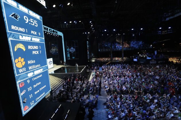 Fans watch as the Carolina Panthers are on the clock for their selection during the first round of the 2017 NFL football draft, Thursday, April 27, 2017, in Philadelphia. Nearly 100,000 people attended the festivities surrounding the first night of the NFL draft Thursday. That's more than at any Super Bowl except one. (AP Photo/Julio Cortez)