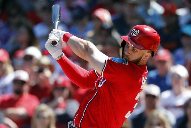 File-This March 3, 2018, file photo shows Washington Nationals' Bryce Harper batting during the first inning of an exhibition spring training baseball game against the Houston Astros in West Palm Beach, Fla.  Right from the start of spring training, Harper declared that he would not entertain a single question pertaining to anything beyond the upcoming season. That's because he can become a free agent after 2018 and that topic will be one everyone else will want to discuss for the next several months. (AP Photo/Jeff Roberson, File)