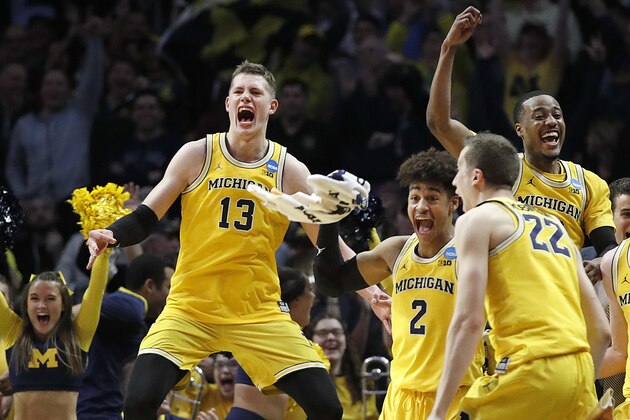 Michigan forward Moritz Wagner (13), guard Jordan Poole (2), guard Muhammad-Ali Abdur-Rahkman, top left, and guard Duncan Robinson (22) celebrate during the second half of the team's NCAA men's college basketball tournament regional semifinal against Texas A&M on Thursday, March 22, 2018, in Los Angeles. (AP Photo/Jae Hong)