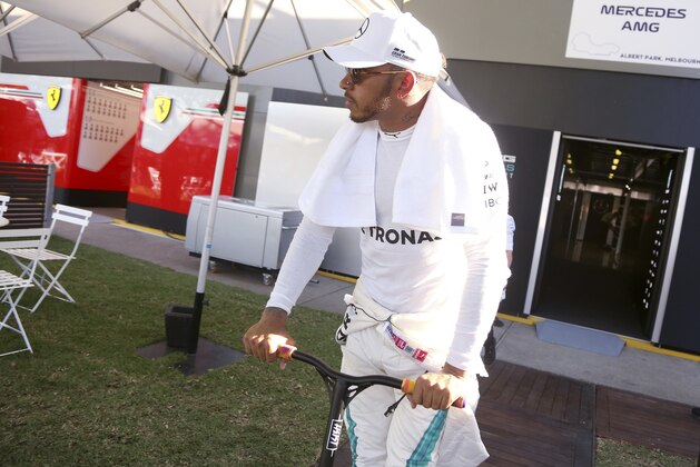Mercedes driver Lewis Hamilton of Britain rides a scooter after the second practice session at the Australian Formula One Grand Prix in Melbourne, Friday, March 23, 2018. The first race of the 2018 seasons is on Sunday. (AP Photo/Asanka Brendon Ratnayake)
