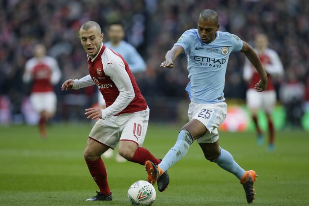 Arsenal's Jack Wilshere, left, vies for the ball with Manchester City's Fernandinho during the English League Cup Final between Arsenal and Manchester City at Wembley stadium in London, Sunday, Feb. 25, 2018.(AP Photo/Tim Ireland)