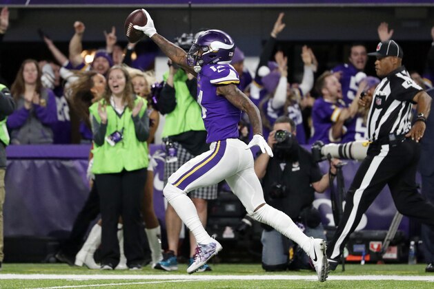 Minnesota Vikings wide receiver Stefon Diggs (14) runs in for a game winning touchdown against the New Orleans Saints during the second half of an NFL divisional football playoff game in Minneapolis, Sunday, Jan. 14, 2018. The Vikings defeated the Saints 29-24. (AP Photo/Jeff Roberson)