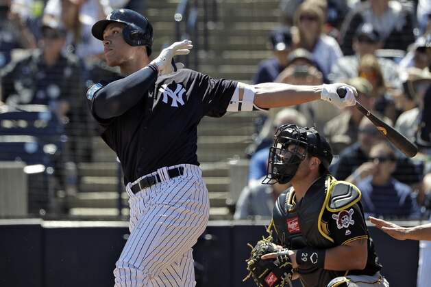 New York Yankees' Aaron Judge follows the flight of his RBI double off Pittsburgh Pirates starting pitcher Joe Musgrove during the first inning of a spring training baseball game Thursday, March 15, 2018, in Tampa, Fla. Yankees' Brett Gardner scored on the hit. Catching for the Pirates is Francisco Cervelli. (AP Photo/Chris O'Meara)