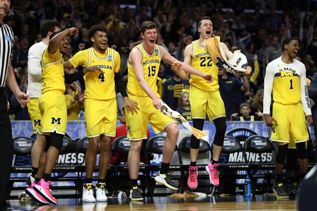 LOS ANGELES, CA - MARCH 22:  The Michigan Wolverines bench celebrates their teams lead over the Texas A&M Aggies during the second half in the 2018 NCAA Men's Basketball Tournament West Regional at Staples Center on March 22, 2018 in Los Angeles, California. The Michigan Wolverines defeated the Texas A&M Aggies 99-72.  (Photo by Ezra Shaw/Getty Images)