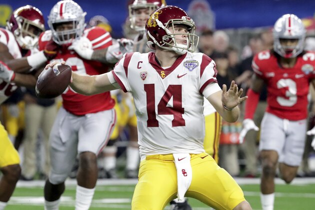 Southern California quarterback Sam Darnold (14) throws a pass with teammates providing blocking against Ohio State during the first half of the Cotton Bowl NCAA college football game in Arlington, Texas, Friday, Dec. 29, 2017. (AP Photo/LM Otero)