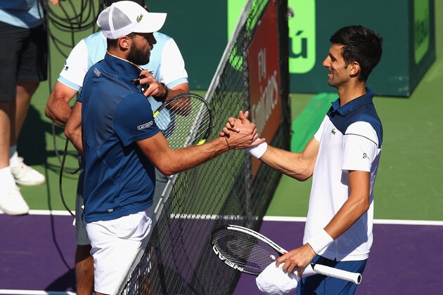 KEY BISCAYNE, FL - MARCH 23:  Novak Djokovic of Serbia at the net after his straight sets defeat by Benoit Paire of France in their second round match during the Miami Open Presented by Itau at Crandon Park Tennis Center on March 23, 2018 in Key Biscayne, Florida.  (Photo by Clive Brunskill/Getty Images)