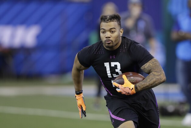 LSU running back Derrius Guice runs a drill during the NFL football scouting combine, Friday, March 2, 2018, in Indianapolis. (AP Photo/Darron Cummings)