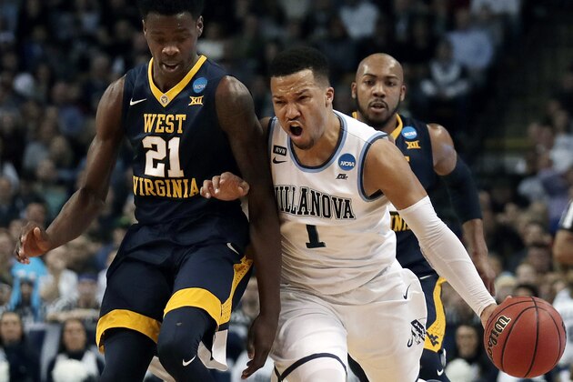 Villanova's Jalen Brunson, right, tries to drive past West Virginia's Wesley Harris, left, during the first half of an NCAA men's college basketball tournament regional semifinal Friday, March 23, 2018, in Boston. (AP Photo/Charles Krupa)