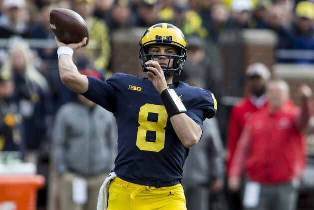 Michigan quarterback John O'Korn (8) throws a pass in the first quarter of an NCAA college football game against Ohio State in Ann Arbor, Mich., Saturday, Nov. 25, 2017. (AP Photo/Tony Ding)
