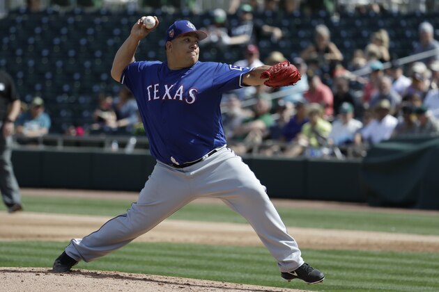 Texas Rangers starting pitcher Bartolo Colon throws against the Oakland Athletics during the first inning of a spring baseball game in Mesa, Ariz., Tuesday, March 6, 2018. (AP Photo/Chris Carlson)