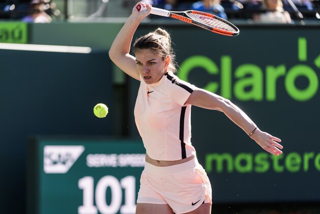 KEY BISCAYNE, FL - MARCH 22: Simona Halep of Romania hits the ball into the ground in frustration against Oceane Dodin of France during Day 4 of the Miami Open Presented by Itau at Crandon Park Tennis Center on March 22, 2018 in Key Biscayne, Florida. (Photo by Mike Frey/Getty Images)