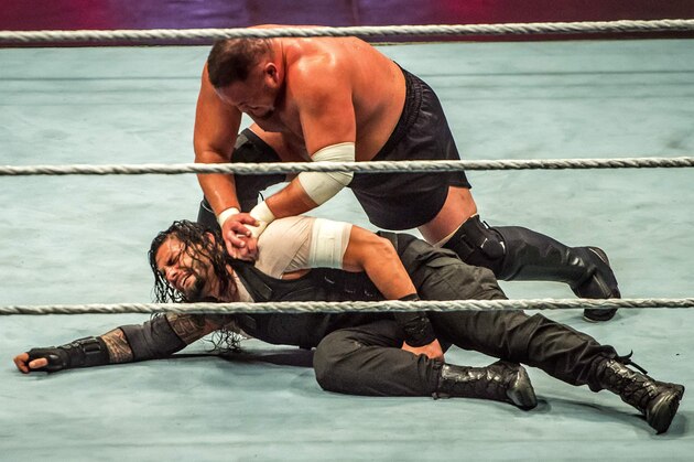 Roman and Samoa Joe (R) battle during the WWE show at Zenith Arena on may 09, 2017 in Lille, France. / AFP PHOTO / PHILIPPE HUGUEN        (Photo credit should read PHILIPPE HUGUEN/AFP/Getty Images)