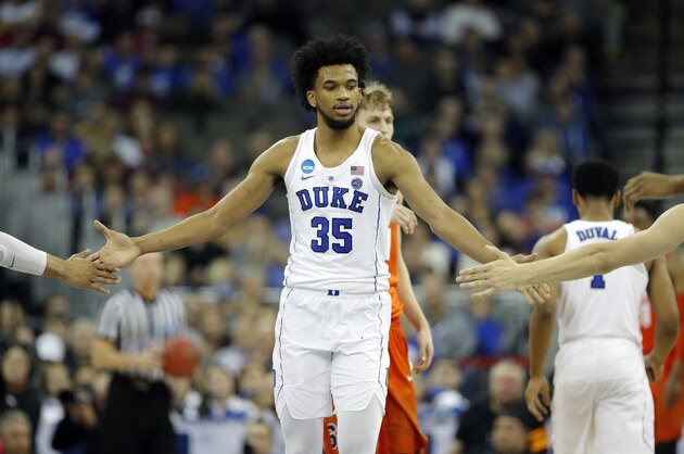 Duke's Marvin Bagley III is congratulated by teammates during the second half of a regional semifinal game against Syracuse in the NCAA men's college basketball tournament Friday, March 23, 2018, in Omaha, Neb. (AP Photo/Charlie Neibergall)
