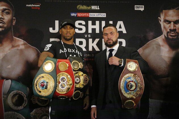 World Heavyweight boxers Anthony Joshua of Britain, left, and New Zealand's Joseph Parker hold their belts as they pose for photographers after a media conference in London, Tuesday, Jan. 16, 2018.  Their unification title bout with Joshua's IBF, WBA (Super) and IBO heavyweight titles and Parker's WBO heavyweight title on the line will take place at the Principality Stadium in Cardiff on March 31, 2018. (AP Photo/Frank Augstein)