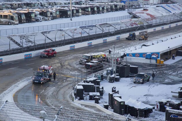 Titan Track Dryers work to clear the track at Martinsville Speedway in Martinsville, Va., Sunday, March 25, 2018. The NASCAR Cup Series race at Martinsville Speedway was postponed until Monday because of inclement weather. (AP Photo/Matt Bell)