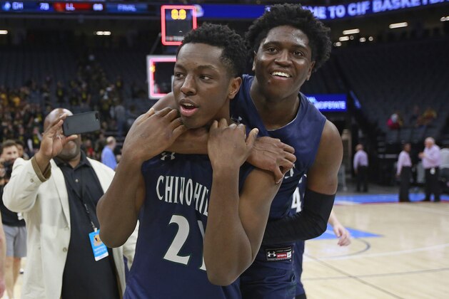 Serra forward Onyeka Okongwu, left, is hugged by teammate Ofure Ujadghele after defeating Las Lomas 73-68 in the boy's Division I high school championship basketball game Friday, March 23, 2018, in Sacramento, Calif. (AP Photo/Rich Pedroncelli)