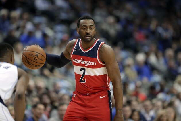 Washington Wizards guard John Wall (2) handles the ball as Dallas Mavericks' Dennis Smith Jr. (1) defends during an NBA basketball game, Monday, Jan. 22, 2018, in Dallas. (AP Photo/Tony Gutierrez)