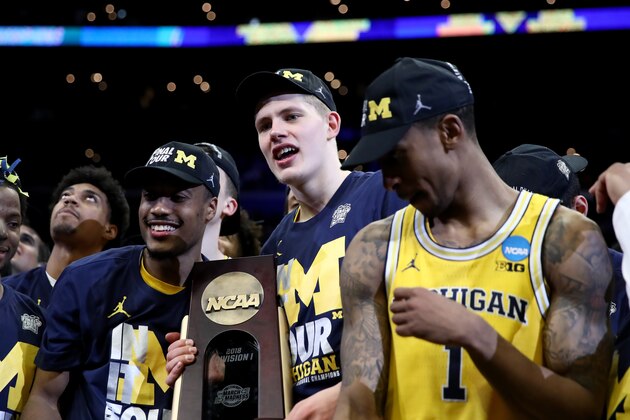 LOS ANGELES, CA - MARCH 24:  Moritz Wagner #13 of the Michigan Wolverines celebrates with the West Regional trophy after their 58-54 victory against the Florida State Seminoles in the 2018 NCAA Men's Basketball Tournament West Regional Final at Staples Center on March 24, 2018 in Los Angeles, California.  (Photo by Ezra Shaw/Getty Images)