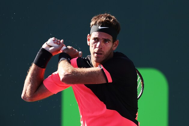 KEY BISCAYNE, FL - MARCH 25:  Juan Martin Del Potro of Argentina returns a shot against Kei Nishikori of Japan during Day 7 of the Miami Open at the Crandon Park Tennis Center on March 25, 2018 in Key Biscayne, Florida.  (Photo by Al Bello/Getty Images)