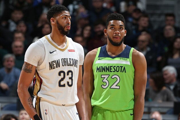 MINNEAPOLIS, MN - FEBRUARY 3: Anthony Davis #23 of the New Orleans Pelicans and Karl-Anthony Towns #32 of the Minnesota Timberwolves look on during the game on February 3, 2018 at Target Center in Minneapolis, Minnesota. NOTE TO USER: User expressly acknowledges and agrees that, by downloading and or using this Photograph, user is consenting to the terms and conditions of the Getty Images License Agreement. Mandatory Copyright Notice: Copyright 2018 NBAE (Photo by David Sherman/NBAE via Getty Images)