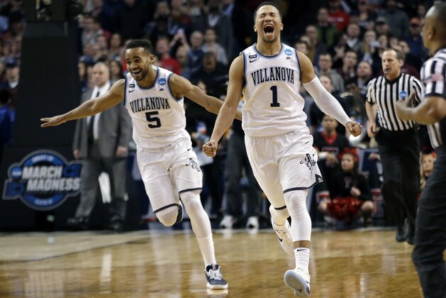 Villanova's Phil Booth, left, and Jalen Brunson celebrate their win over Texas Tech in an NCAA men's college basketball tournament regional final, Sunday, March 25, 2018, in Boston. Villanova won 71-59 to advance to the Final Four. (AP Photo/Elise Amendola)