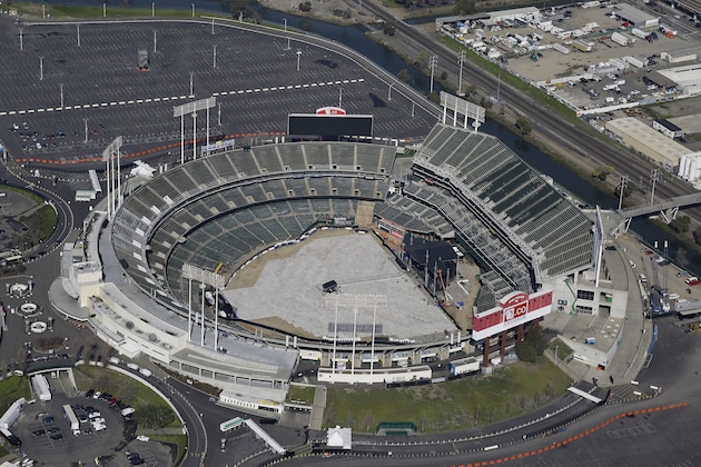 FILE - This Feb. 5, 2016, file photo shows Overstock.com Coliseum, also known as the Oakland–Alameda County Coliseum, home to the Oakland Athletics, in Oakland, Calif. Baseball Commissioner Rob Manfred is willing to wait - to a point - for the Tampa Bay Rays and the Athletics to get new ballparks. Tampa Bay and Oakland are the only two major league teams currently seeking new stadiums. (AP Photo/Eric Risberg, File)