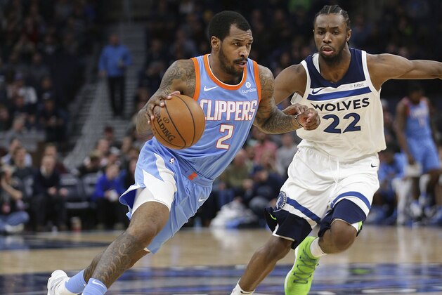 Los Angeles Clippers guard Sean Kilpatrick (2) against Minnesota Timberwolves forward Andrew Wiggins (22) in the third quarter of an NBA basketball game Tuesday, March 20, 2018, in Minneapolis. The Timberwolves defeated the Clippers 123-109. (AP Photo/Andy Clayton-King)