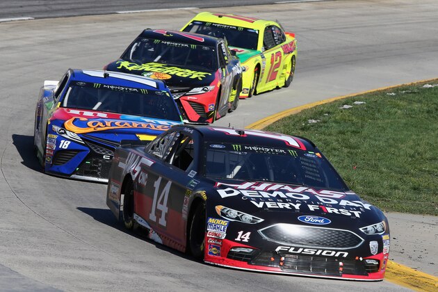 MARTINSVILLE, VA - MARCH 26:  Clint Bowyer, driver of the #14 Haas Automation Demo Day Ford, leads a pack of cars during the weather delayed Monster Energy NASCAR Cup Series STP 500 at Martinsville Speedway on March 26, 2018 in Martinsville, Virginia.  (Photo by Jerry Markland/Getty Images)